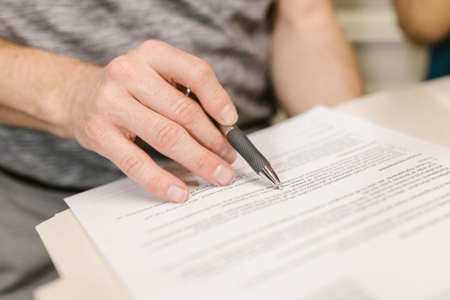 Person reviewing and signing a printed probate document in leed county kentucky