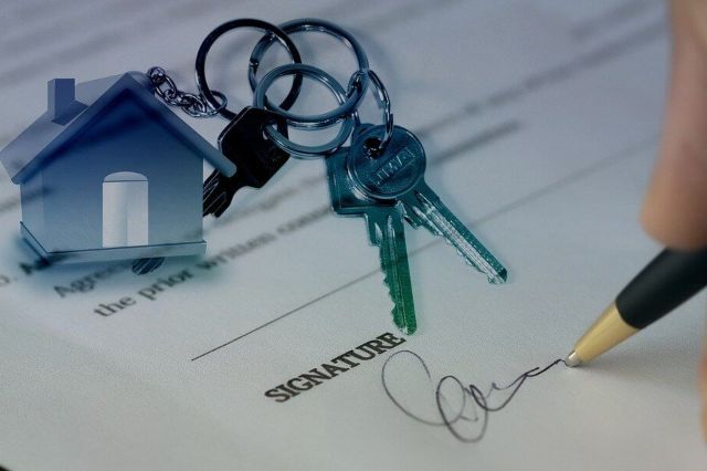 Person signing a house purchase contract