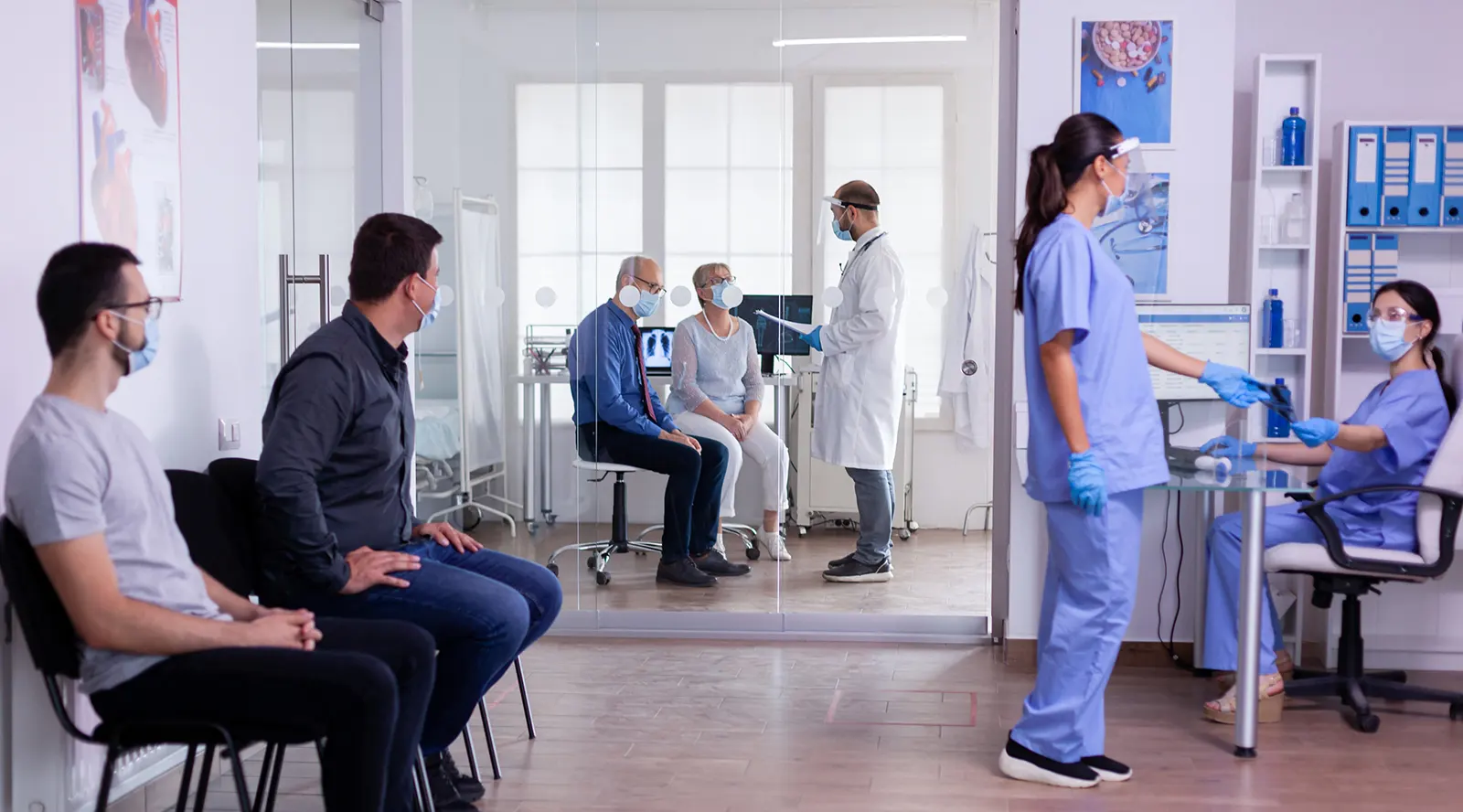 Patients waiting and doctors working in medical clinic