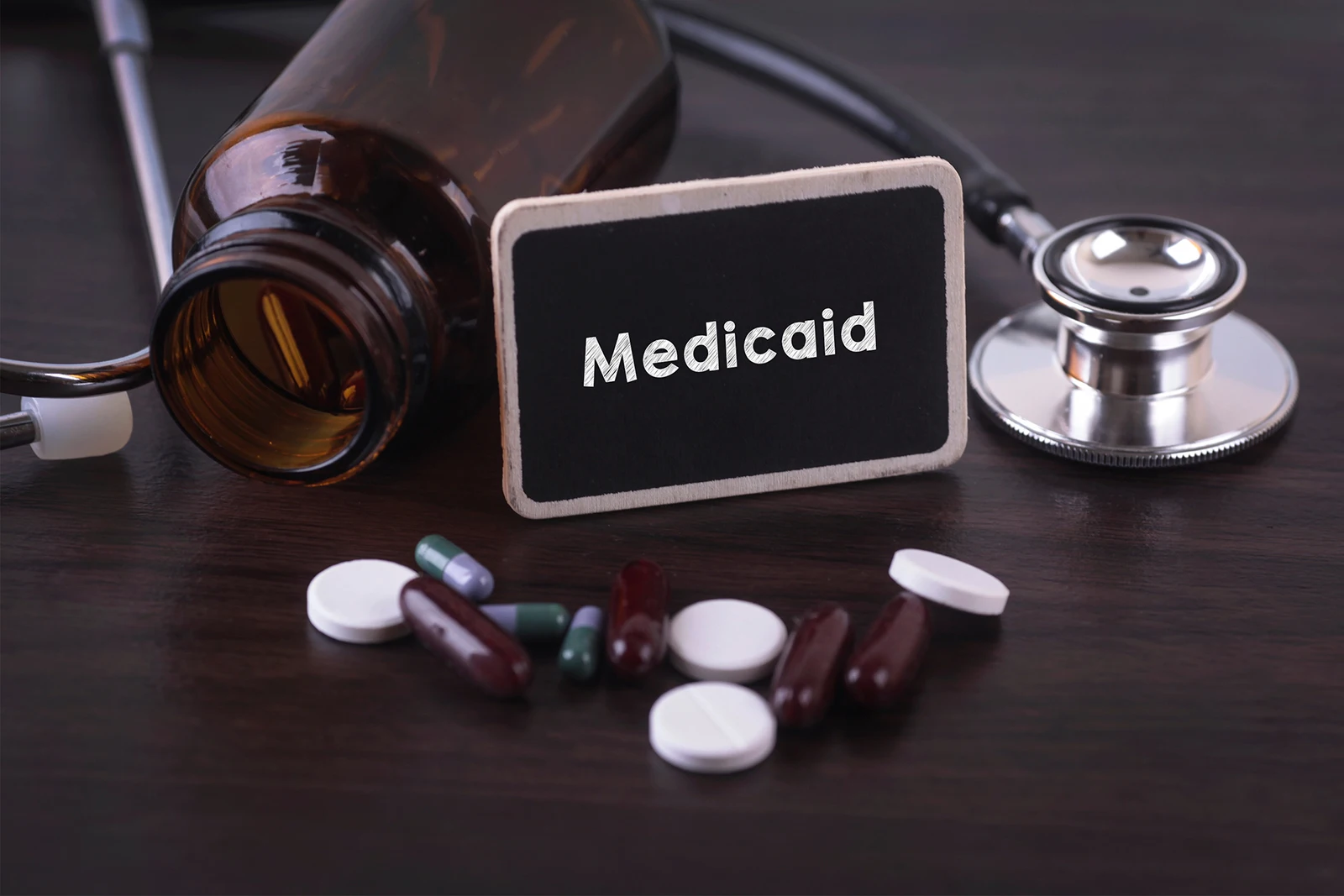 Medicaid sign with pills and stethoscope