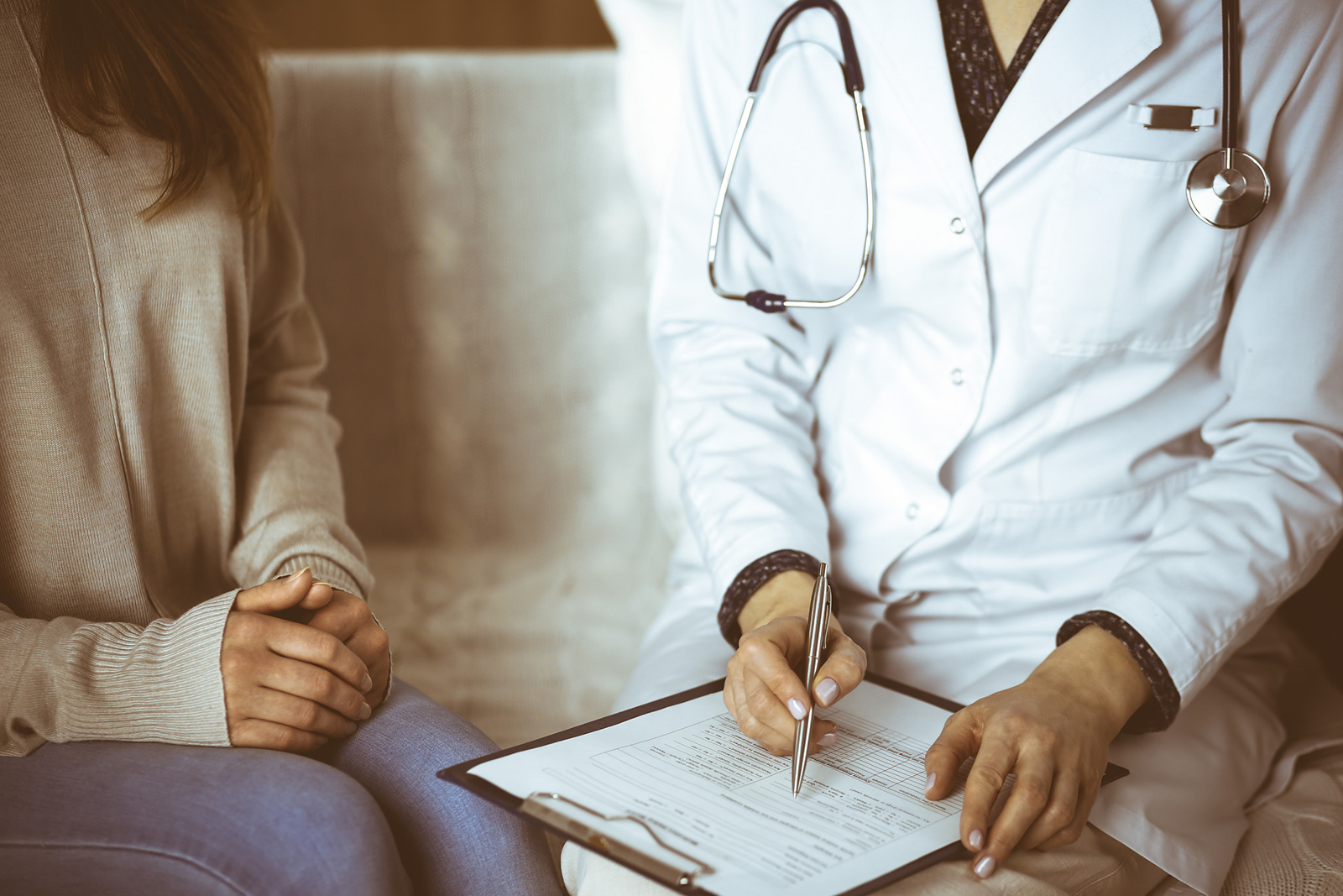 Doctor consulting patient and filling medical form for healthcare surrogacy in kentucky