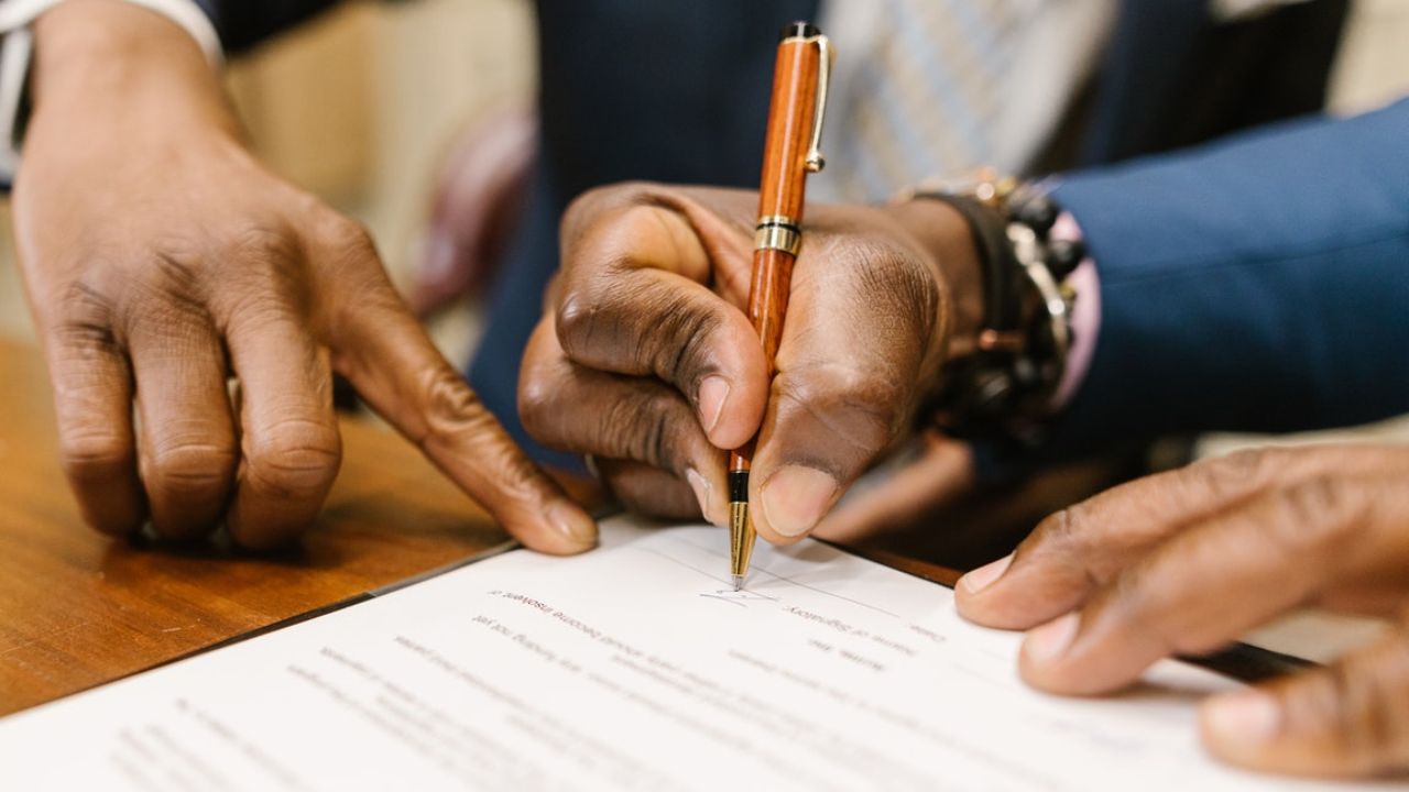 Person signing a legal document
