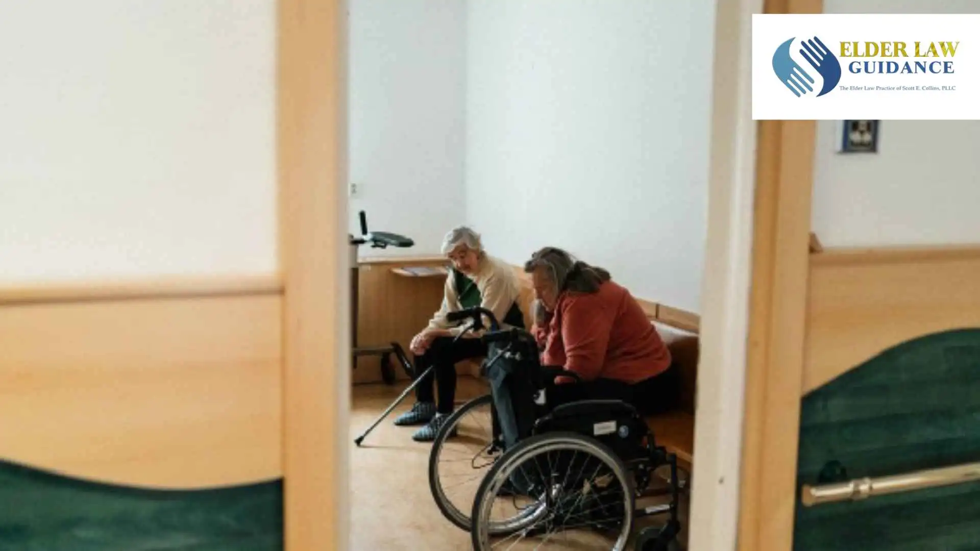 Two senior women conversing indoors, one in a wheelchair, symbolizing companionship in a nursing home setting, illustrating mediciad crisis planning lawyer in Corbin. Branded with the Elder Law Guidance logo.